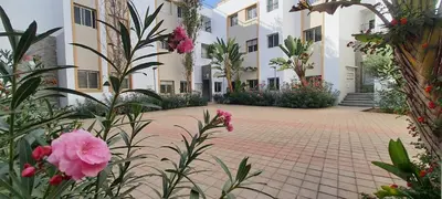 a courtyard of a building with flowers and plants at Settat room Homy in Settat