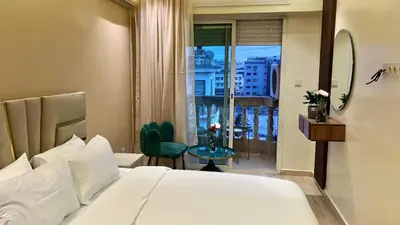a bedroom with a bed and a view of a city at Stylish 2BR Appartement Central - 5 min Casa port in Casablanca