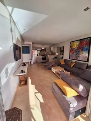 a living room with a couch and a table at Appartement piscine front de mer in Mohammedia