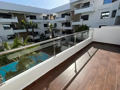a balcony of a apartment with a swimming pool at Appartement Cosy Vue sur Mer in Dar Bouazza