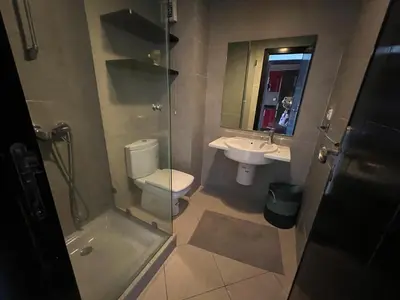 a bathroom with a toilet and a sink and a shower at Appartement Cosy Vue sur Mer in Dar Bouazza