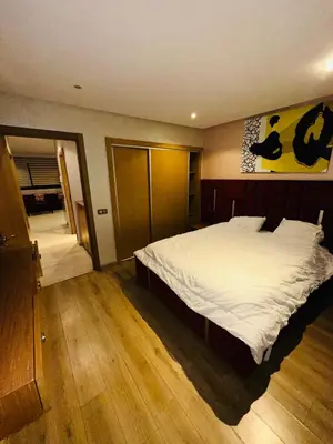 a bedroom with a large bed and wooden floors at STUDIO CASABLANCA BEsT STAY 1 in Casablanca