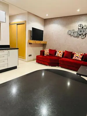 a living room with a red couch and a tv at STUDIO CASABLANCA BEsT STAY 1 in Casablanca