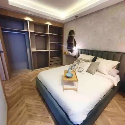 a bedroom with a large bed with a table on it at Downtown Luxury Stay CIL in Casablanca