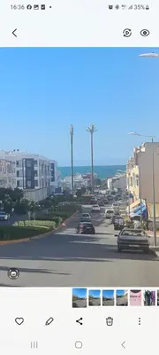two photographs of a street with cars on the road at Belle maison à Harhoura proche de la plage in Rabat