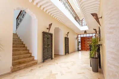 a hallway with stairs and a door in a house at Château Loriana in Bouznika