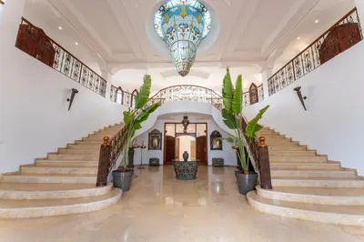 a lobby with stairs and a stained glass window at Château Loriana in Bouznika