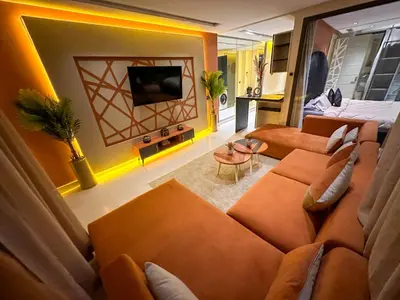 a living room with a couch and a tv at Cosy in Casablanca