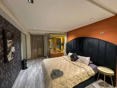 a bedroom with a large bed with a large headboard at Cosy in Casablanca