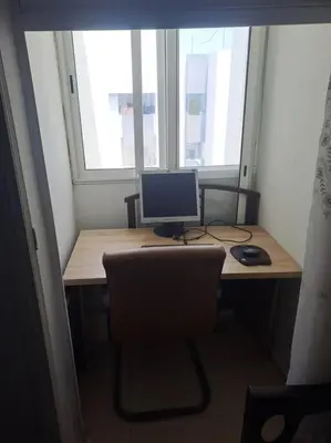 a desk with a computer monitor and a keyboard and mouse at Moonskhirat in Skhirat