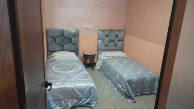 a small room with two beds and a mirror at Msn in Rabat