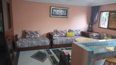a living room with two couches and a table at Msn in Rabat