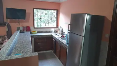 a kitchen with a stainless steel refrigerator and a window at Msn in Rabat