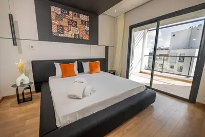a bedroom with a large bed with two towels on it at Sophisticated 3BR with Ample Space & Top Amenities in Rabat