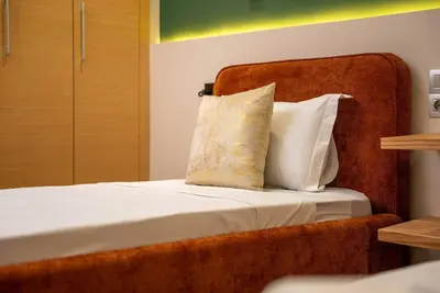 a bed with two pillows sitting on top of it at Sophisticated 3BR with Ample Space & Top Amenities in Rabat