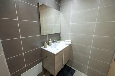 a bathroom with a sink and a mirror at Sophisticated 3BR with Ample Space & Top Amenities in Rabat