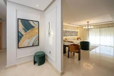 a living room with a table and chairs and a couch at Sophisticated 3BR with Ample Space & Top Amenities in Rabat