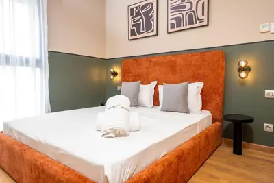 a bedroom with a large bed with white sheets at Prestigia Gem Spacious 3BR Flat in Hay Riad in Rabat