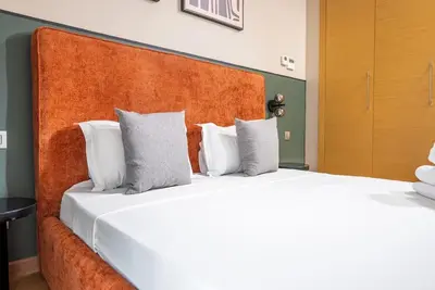 two beds with white pillows in a bedroom at Prestigia Gem Spacious 3BR Flat in Hay Riad in Rabat