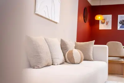 a white couch with pillows in a living room at Prestigia Gem Spacious 3BR Flat in Hay Riad in Rabat