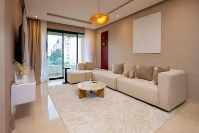 a living room with a couch and a table at Prestigia Gem Spacious 3BR Flat in Hay Riad in Rabat