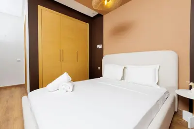 a white bed with a stuffed animal on top of it at Luxury 3BR Homelike Stay in Hay Riad in Rabat