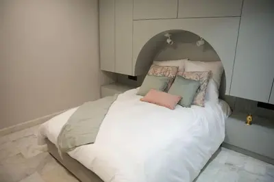 a bedroom with a white bed with pillows on it at Fabuleux appart Casa port Marina in Casablanca