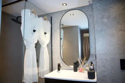 a bathroom with a white sink and a mirror at Fabuleux appart Casa port Marina in Casablanca
