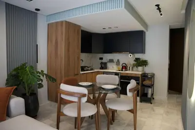 a kitchen with a table and chairs in a room at Fabuleux appart Casa port Marina in Casablanca