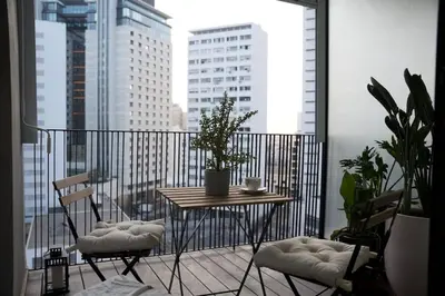 a balcony with a table and chairs on a balcony at Fabuleux appart Casa port Marina in Casablanca