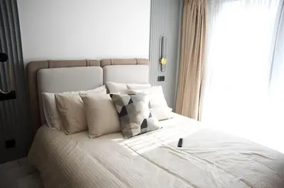 a bed with white sheets and pillows next to a window at Fabuleux appart Casa port Marina in Casablanca