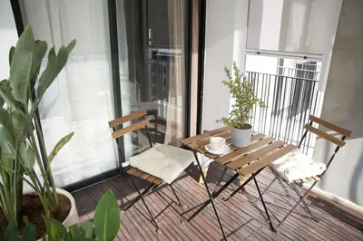 a table and chairs on a balcony with plants at Fabuleux appart Casa port Marina in Casablanca