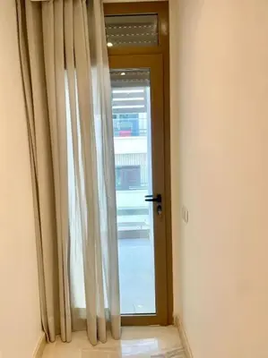 a room with a door and a window with curtains at Casablanca in Casablanca