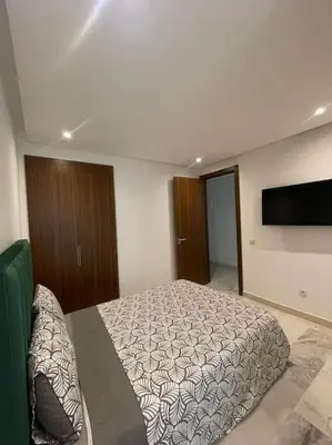 a bedroom with a bed and a flat screen tv at Casablanca in Casablanca