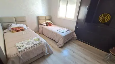 a small room with two beds and a window at ANFA BLANCa in Casablanca