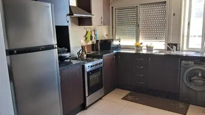 a kitchen with a refrigerator and a stove and a dishwasher at ANFA BLANCa in Casablanca