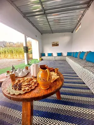 a table with a vase on it in a room at Ferme de luxe in O Ben Slimane