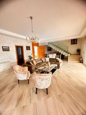 a large living room with a couch and chairs at Ferme de luxe in O Ben Slimane