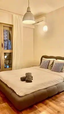a large bed in a bedroom with a stuffed animal on it at Élégant Appartement 200m Au Coeur De Casablanca ! in Casablanca