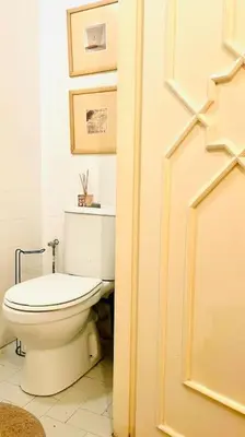 a bathroom with a white toilet in a room at Élégant Appartement 200m Au Coeur De Casablanca ! in Casablanca