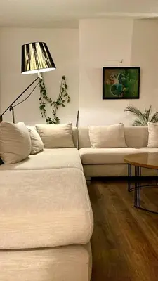 a living room with two white couches and a lamp at Élégant Appartement 200m Au Coeur De Casablanca ! in Casablanca