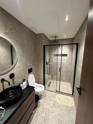 a bathroom with a shower and a toilet and a sink at Studio Anfa Living 1 in Casablanca
