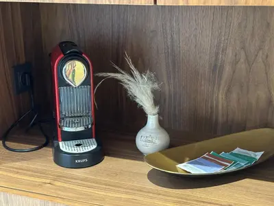 a clock sitting on a table next to a vase at Studio Anfa Living 1 in Casablanca