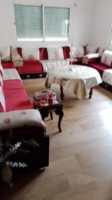 a living room with a couch and a table at émeraude house family in Casablanca