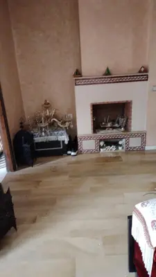 a living room with a fireplace in a room at émeraude house family in Casablanca