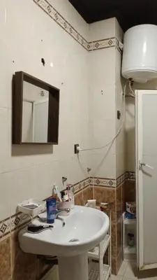 a bathroom with a white sink and a mirror at émeraude house family in Casablanca