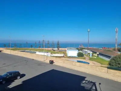 a parking lot with a car parked next to the ocean at Apartment Ocean View 2Br in Casablanca
