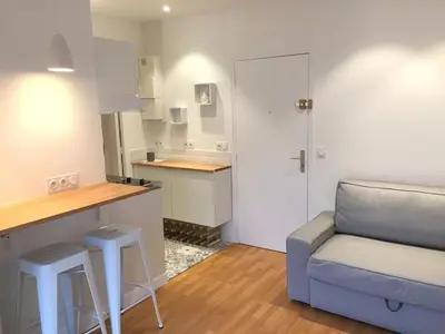a living room with a couch and a kitchen at studio in Casablanca