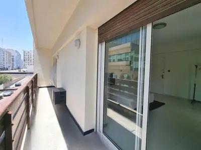 a balcony with a large glass window on a building at Appartement lumineux plein-centre, parfait pour explorer ! in Casablanca