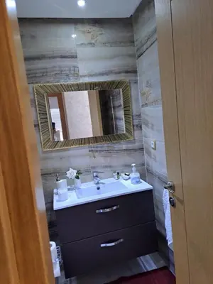 a bathroom with a sink and a mirror at les sables d'or in Temara